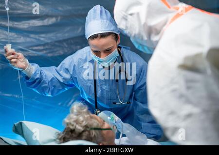 Infected patient in quarantine lying in bed in hospital, coronavirus concept. Stock Photo