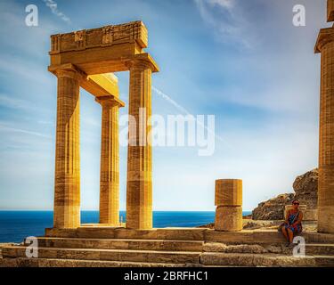 LINDOS, GREECE - OCTOBER 04, 2018: A tourist at the Lindos acropolis on the Greek island of Rhodes. Stock Photo