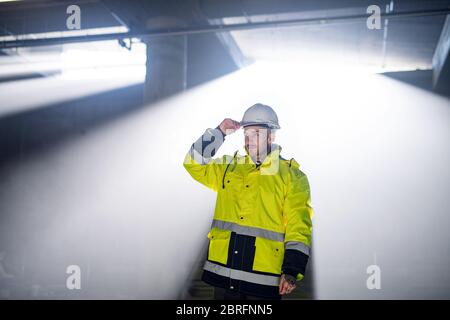 Man worker outdoors on construction site, working. Stock Photo
