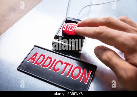 Man Pressing Stop Addiction Emergency Red Button Stock Photo