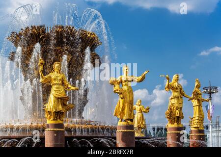 The Peoples Friendship Fountain in All-Russia Exhibition Centre (VDNKh). It was built in the 50s. 16 golden sculptures represent republics of the Sovi Stock Photo
