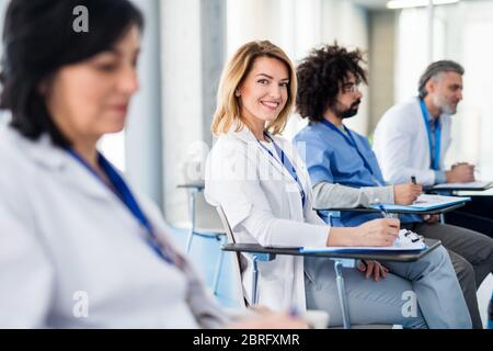 Group of doctors listening to presentation on medical conference. Stock Photo