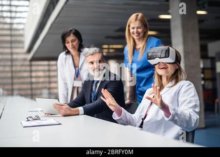 Doctors and pharmaceutical sales representative using VR goggles. Stock Photo