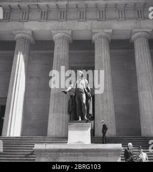 1950s, historical, exterior view of the Federal Hall, a grand columned building in Manhattan, New York, USA. Opened in 1842 for the U.S Custom House for the Port of New York and built in the Greek revival architectural style, it served as a sub-treasury building and replaced an earlier building officially known as 'Federal Hall'. The bronze statue of George Washington by John Qunicy Adams Ward on the steps of the building commemorates the place where he was sworn in as the nation's first president.