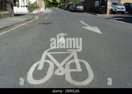 british road marking indicating a contraflow cycle route on a street that is one-way for motor traffic, in twickenham, middlesex, england Stock Photo