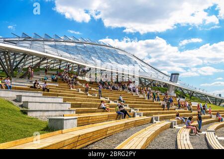 Moscow - June 16, 2018: People visit the modern amphitheater with glass cupola in Zaryadye Park in summer in central Moscow, Russia. Zaryadye is one o Stock Photo