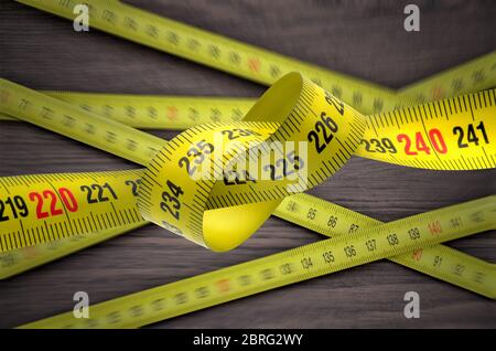 tangled yellow tape measure Stock Photo