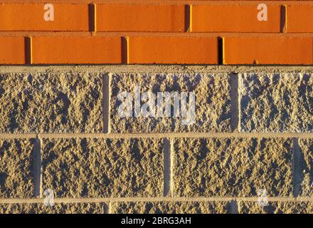 Mix of red tiles and grey stone tiles used on wall construction Stock Photo