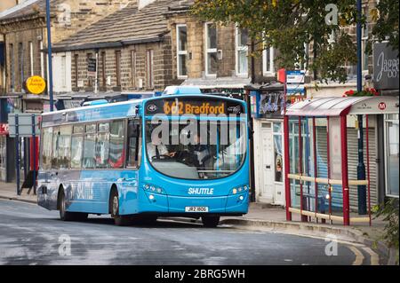 Single decker bus bound for Bradford stopping at a bus stop in Yorkshire, England.