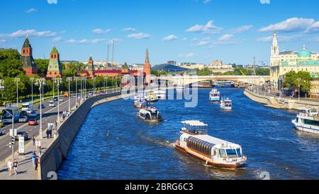 Moscow – May 19, 2019: Panorama of Moskva River in Moscow, Russia. People walk on Kremlin Embankment in summer. Cityscape of Moscow with tourist boats Stock Photo