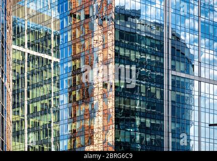 Abstract architecture background. Sky and buildings are reflected in the office skyscraper facade. Concept of modern constructions and business. Beaut Stock Photo