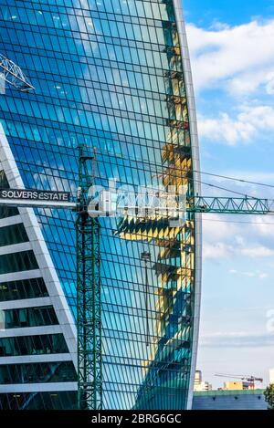 Moscow - Sep 10, 2017: Construction site crane and modern Evolution Tower in Moscow-City, Russia. Moscow-City is a district with business tall buildin Stock Photo