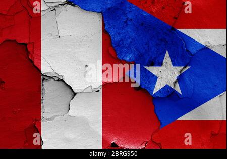 flags of Peru and Puerto Rico painted on cracked wall Stock Photo