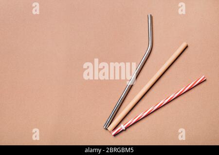 Different kinds of straws. Reusable bamboo, stainless steel and single-use plastic. Zero-waste, sustainability concept. Stock Photo
