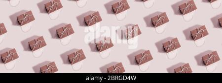 Pattern of gift boxes on pink background. Creative design for packaging. Top view. Flat lay. Horisontal banner Stock Photo