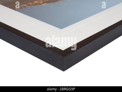 The corner and edge of a high quality wood photo frame complete with mount on a white background. Black picture frames are the most popular choice for Stock Photo