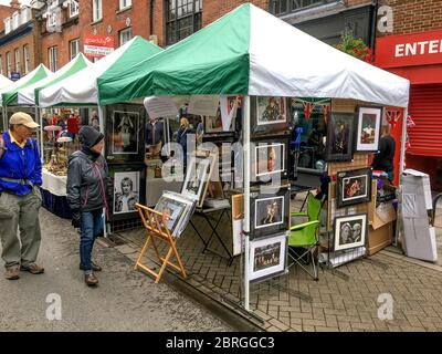 A fine art photography market stall selling framed archive photos of Royalty and celebrity including Princess Diana, David Bowie, HM Queen Elizabeth I Stock Photo