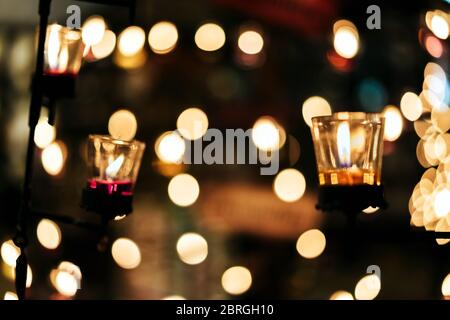 Blured image of A Burning Candle in Clear Glass stick with steel rod Decorated in Hotel, Restaurant or Home. Selective Focus, Blurred Background with Stock Photo