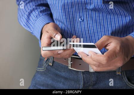 Man holding credit card and using smart phone, online shopping concept Stock Photo