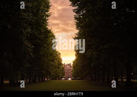 Tunnel of trees in the park with the house at the end Stock Photo