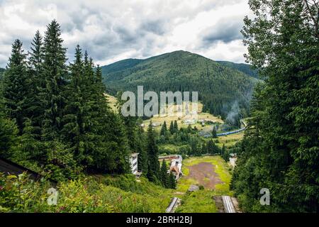 A long train in the mountains of the Carpathians. Bright landscape and train. Stock Photo