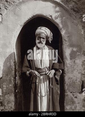 Vintage early 20th century photograph - village chief or sheikh with beads Stock Photo