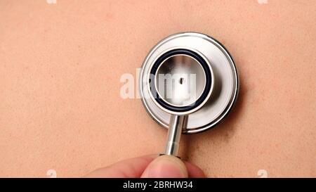 Medic checking chest person in office at the hospital. Close up Stock Photo