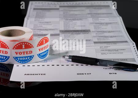Morgantown, WV - 21 May 2020: West Virginia state primary election absent ballot form with focus on the word Absentee and on I Voted Today sticker Stock Photo
