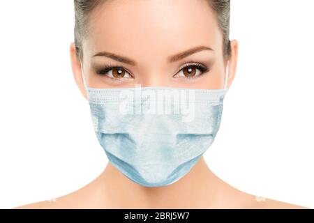 Beautiful Asian woman wearing medical face mask with eyes makeup beauty model portrait isolated on white background for Coronavirus. Stock Photo