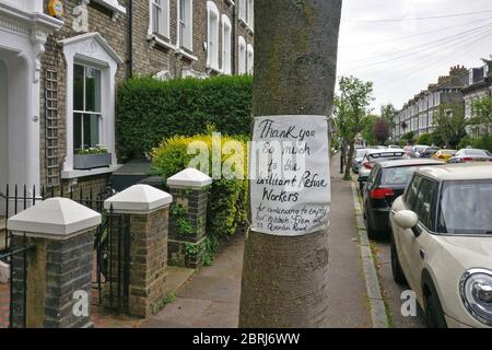 London, United Kingdom - April 27, 2020: Hand drawn thank you note to rubbish collectors displayed at tree on street in Lewisham, during coronavirus c Stock Photo