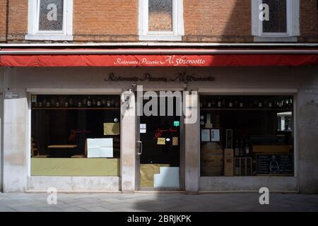 VENICE, ITALY - MAY: A restaurant still closed is seen on May 18, 2020 in Venice, Italy. Restaurants, bars, cafes, hairdressers and other shops have r Stock Photo