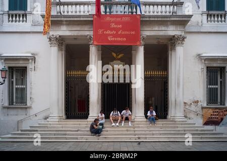 VENICE, ITALY - MAY: Tourists rest on the stairs of the theater La Fenice on May 18, 2020 in Venice, Italy. Restaurants, bars, cafes, hairdressers and