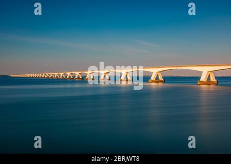 Long exposure of the Zeeland Bridge in Zierikzee, Zeeland province, Netherlands around sunset. With 5 km it is the longest bridge in The Netherlands. Stock Photo