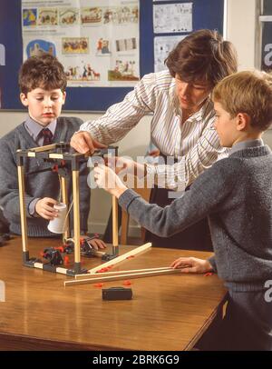 Children building electrical motor in science class, Surrey, England, United Kingdom Stock Photo