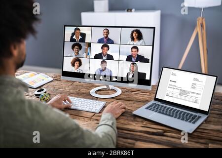 Man Working From Home Having Online Group Videoconference On Laptop Stock Photo