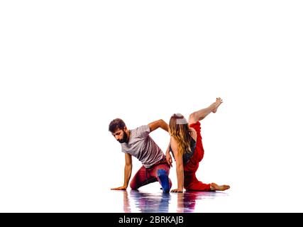 Teenagers skill and talent of modern dance, dancing in studio over white background Stock Photo