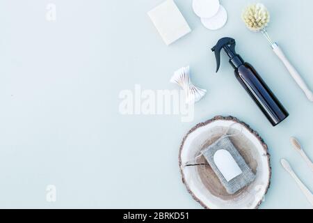 Sustainable products for bathroom on the background spray bottle, rock crystal deodorant, wooden plate Stock Photo