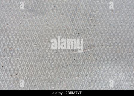 seamless old flat concrete texture with diamond pattern and signs of light erosion. Stock Photo