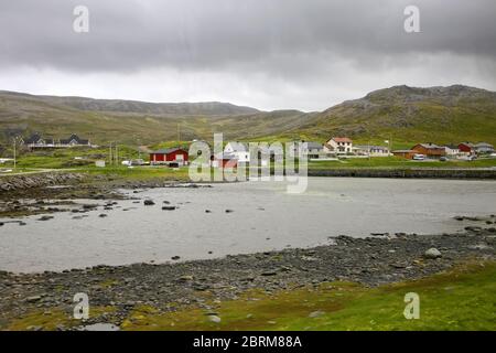 View of the colorful fishing village of Skarsvag with boats docked in ...