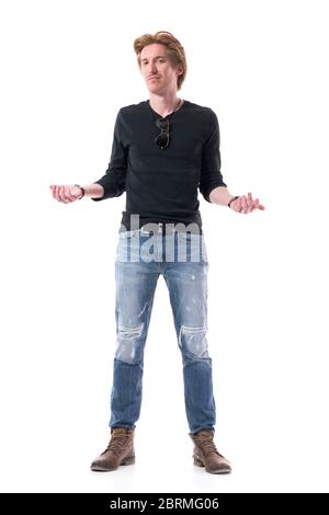 Puzzled uncertain young stylish red hair man model shrugging shoulders with raised hands. Full body length isolated on white background. Stock Photo