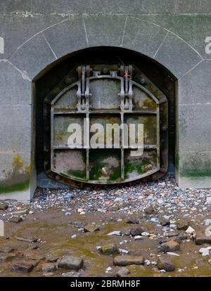 An old sewerage storm overflow outlet on the River Thames Stock Photo