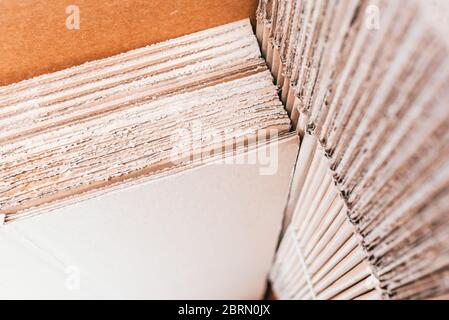 Home moving using corrugated cardboard boxes as protection material, detail. Stock Photo