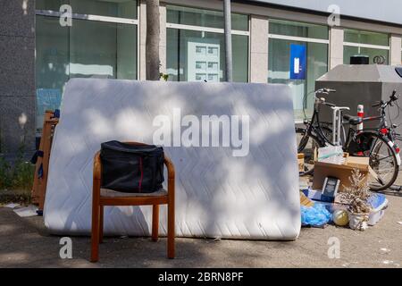 Unwanted furniture and household stuffs left outside on sidewalk and street in Germany. Used furniture wait for picked up because moving out the house Stock Photo