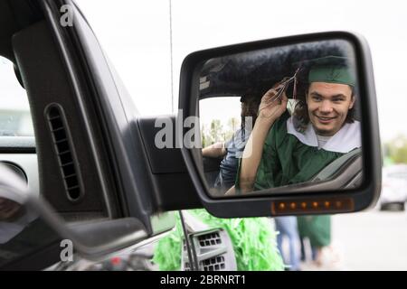 Washington, Untied States. 21st May, 2020. Ben Bartles adjusts his tassel in the mirror of his truck before the start of his drive-through graduation ceremony at Musselman High School in Inwood, West Virginia on Thursday, May 21, 2020. Due to the COVID-19 pandemic the high school was forced to hold a social-distanced commencement ceremony. Photo by Kevin Dietsch/UPI Credit: UPI/17�Թ����� Live News Stock Photo