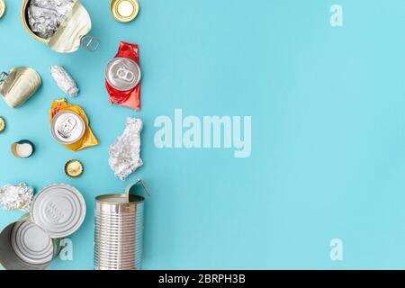 Recyclable metal garbage on the blue background. Waste separation concept. Flatlay, copy space. Stock Photo