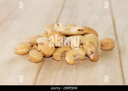 Many Roasted salted cashew nuts  on wooden background Stock Photo