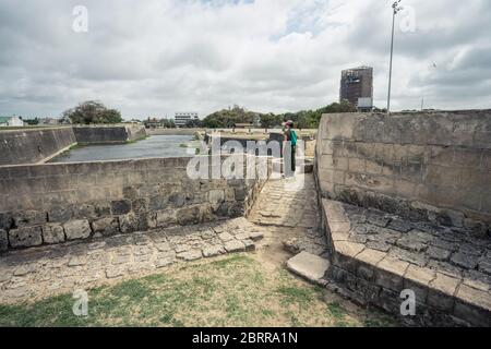 Jaffna / Sri Lanka - August 15, 2019: Asian female yount solo traveller doing tourism in historic Jaffna Fort, fortress, woman tourist