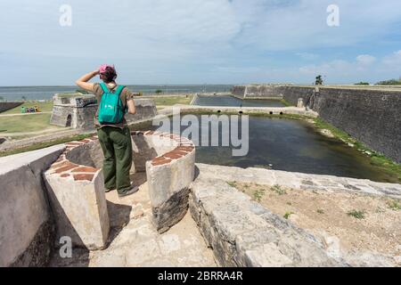 Jaffna / Sri Lanka - August 15, 2019: Asian female yount solo traveller doing tourism in historic Jaffna Fort, fortress, woman tourist