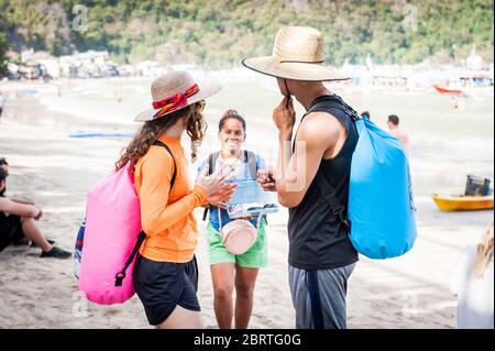 Morning scene at the main beach in El Nido, Philippines as tourists begin to head out on day boats. Stock Photo