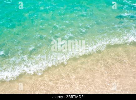 White bubble and Light reflection on the surface of movement sea on the beach Stock Photo